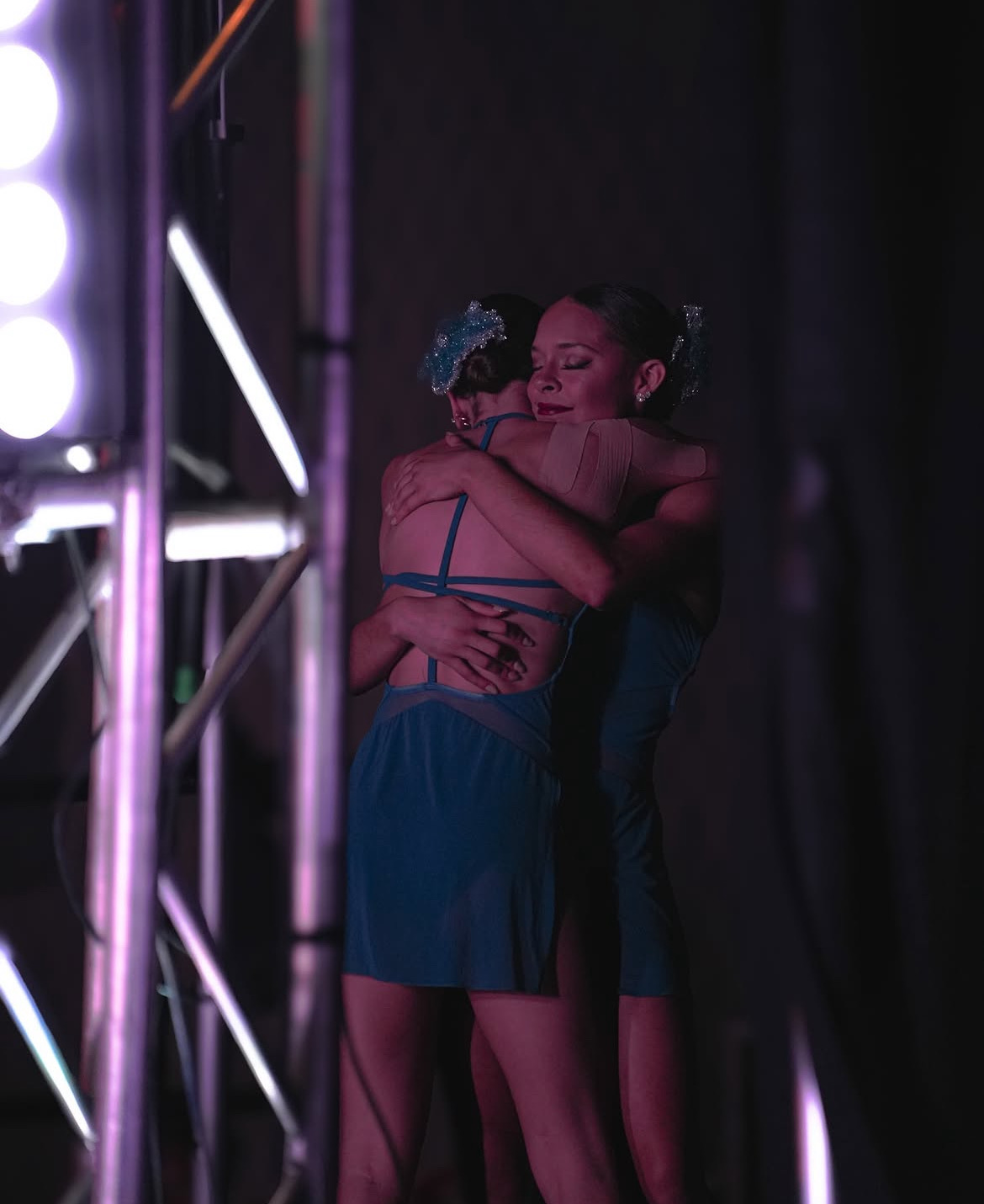 Dancers embracing on stage after a lyrical performance